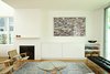 Modern home with Living Room, Bench, Coffee Tables, Chair, Media Cabinet, Medium Hardwood Floor, Storage, and Standard Layout Fireplace. Beside the fireplace is a Nexus 21 lift system, which is used to hide the television when it’s off. Photo 4 of The Ro Residence