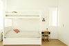 Modern home with Kids Room, Bedroom Room Type, Medium Hardwood Floor, Bed, Pre-Teen Age, and Neutral Gender. Lucas and Noah's bedroom holds a set of bunk beds by Urbangreen. Photo 9 of The Ro Residence