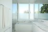 Modern home with Bath Room, Drop In Sink, Alcove Tub, Marble Counter, and Marble Wall. The master bathroom is complete with a honed statuary F Italian white marble slab countertop, shower wall and floor. The honed white Corian tub is by Hydro Systems. Photo 10 of The Ro Residence