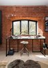 Modern home with Office, Study Room Type, Desk, Light Hardwood Floor, and Chair. The tower, which now holds a study and several other living spaces, was in disrepair. Its original brickwork had to be washed inside and out, and the exterior was coated with a hydrophobic mineral paint by Keim to make it harder for rain to penetrate. Photo 4 of Lister Tower