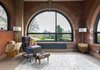 Modern home with Living Room, Table Lighting, End Tables, Chair, Lamps, and Light Hardwood Floor. The couple approached Darren Bray of Lymington-based PAD Studio with a proposal to consolidate and weatherproof the building, while at the same time preserving its original brickwork. "We had in mind a new entrance that would make a good, strong impression," says owner Sheryl Wilson. Architect Darren Bray peeled back the layers of the previous owners' decor to allow the brickwork to breathe. Photo 6 of Lister Tower