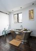 Modern home with Bath Room, Freestanding Tub, and Ceiling Lighting. A freestanding copper tub, also by William Holland, sits exposed in a corner of the bathroom. The matching tile for the vanity and floor is by Marco Polo. Photo 8 of Lister Tower
