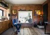Modern home with Living Room, Chair, Light Hardwood Floor, Storage, and Table Lighting. A lens-like window, whose steel frame juts out toward the courtyard, has a built-in beech plywood seat for admiring New Forest National Park. The chair is vintage. Photo 9 of Lister Tower