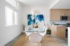 Modern home with Dining Room, Table, Pendant Lighting, and Concrete Floor. The dining room is outfitted with a pair of striking paintings by Vivian Caits. Photo 2 of St. Barts-Inspired Tilley Row Home