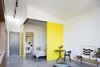 Modern home with Bedroom, Bed, Chair, Concrete Floor, Track Lighting, and Bench. Inside Coppin Street Apartments, MUSK Architecture Studio used flexible floor plans with large sliding doors to demarcate living and sleeping zones. Photo 7 of Coppin Street Apartments