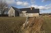 Modern home with Outdoor, Trees, Grass, Back Yard, Shrubs, and Wood Fences, Wall. One of the pitched roofs extends to the ground, concealing an entrance.
-
North Hatley, Quebec
Dwell Magazine : July / August 2017 Photo 8 of Townships Farmhouse