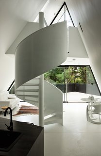 The sharp ridgeline and soaring soffit reference a tent shape in an architecturally elegant way. 