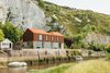 Modern home with Side Yard, Trees, Grass, Exterior, House, Metal Roof Material, and Metal Siding Material. Perched along the banks of the River Ouse near the historic English town of Lewes is a Cor-Ten steel house with a Photo of Cor-Ten Steel-Clad Prefab