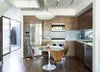 Modern home with Kitchen, Ceramic Tile Backsplashe, Pendant Lighting, Wood Cabinet, Medium Hardwood Floor, Microwave, Refrigerator, and Drop In Sink. The dining area features a custom Eero Saarinen table for Knoll and vintage Arne Jacobsen chairs for Fritz Hansen. KitchenAid appliances, IKEA cabinets, and Home Depot tile furnish the kitchen.
-
Santa Monica, California
Dwell Magazine : July / August 2017 Photo 3 of Hill-Heiserman House