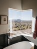 Modern home with Bath Room, Freestanding Tub, and Soaking Tub. The master bathroom features one of two corner windows in the house. “At night, when I take a bath, I can see the moon and the stars,” says Lois.
-
Taos, New Mexico
Dwell Magazine : July / August 2017 Photo 8 of Rodin Residence