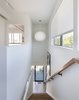 Modern home with Staircase, Wood Tread, and Wood Railing. A George Nelson Bubble lamp hangs in the stairwell. Photo 8 of Hill-Heiserman House