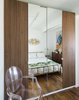 Modern home with Bedroom, Chair, Bed, Storage, and Medium Hardwood Floor. A Curtis Jere sculpture hangs above a bed from CB2 in the upstairs guestroom. The Louis Ghost chair is by Philippe Starck
for Kartell. Photo 13 of Hill-Heiserman House