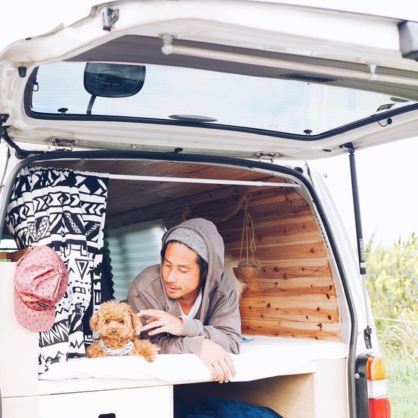 A Japanese couple and their fluffy pooch Roy are traversing the heartland of Japan in their stylish, wood-paneled abode.