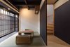 Modern home with Living Room, Chair, Light Hardwood Floor, Coffee Tables, Recessed Lighting, and Rug Floor. Traditionally home to merchants and craftspeople, a machiya is a type of Japanese wooden townhouse that originated in the Heian period and developed through the Edo and Meiji periods. Photo of BenTen Residences