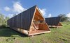 Modern home with Exterior, Cabin Building Type, Wood Siding Material, and Glass Siding Material. The warm wood construction and sleek "primitive-modern" look captures the energy of the island. Photo 2 of Morerava Cabins