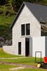Modern home with Exterior, Gable RoofLine, Stone Siding Material, House Building Type, Cabin Building Type, Tile Roof Material, Glass Siding Material, and Concrete Siding Material. The only clue to the property's past life are the train tracks which traverse the garden. Photo 2 of La Micheline