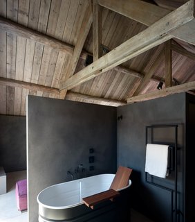 Each room comes equipped with an en suite bathroom. This one includes a stylish bathtub by Agape. 