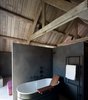 Modern home with Bath Room, Freestanding Tub, and Concrete Floor. Each room comes equipped with an en suite bathroom. This one includes a stylish bathtub by Agape. Photo 10 of La Micheline