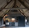 Modern home with Kitchen, Concrete Floor, Wall Lighting, Wall Oven, Drop In Sink, Refrigerator, and Accent Lighting. An additional kitchen has been placed in the loft for added convenience. Photo 9 of La Micheline