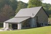 Modern home with Exterior, House Building Type, Tile Roof Material, Stone Siding Material, Gable RoofLine, Cabin Building Type, Glass Siding Material, and Concrete Siding Material. The ground floor of the two-story structure includes a living room, dining room, and three bedrooms—all with en-suite bathrooms. It also features a huge loft area with an additional living space, bedroom, kitchen, and bathroom. Each level has an outdoor terrace, while the lower terrace has a barbecue. Photo 4 of La Micheline