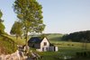 Modern home with Outdoor, Field, Trees, Grass, Hardscapes, and Walkways. Situated on 25 acres of rolling fields just outside the village of Bioul, Belgium, the charming home was renovated and designed by architect Stéphane Lebrun of Kyo-co Atelier. The interiors were designed and photographed by Jean-Luc Laloux. What makes the property so unique is that the old out-of-service train tracks still wind throughout the property and have created a playground where kids and parents alike can push each other around on little makeshift cars. Photo of La Micheline