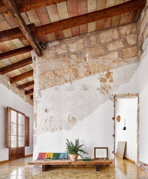 Architect Carles Oliver rehabbed an old, empty building in Palma de Mallorca, Spain, over the course of three years for just over $21,000. While the majority of the budget went towards improving energy efficiency, such as installing roof insulation, the rest was spent on removing layers of architecture to reveal the original construction, including the stone-clad walls and wooden ceilings.