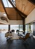 Modern home with Living Room, Hanging Fireplace, Lamps, Sofa, Coffee Tables, Floor Lighting, Rug Floor, End Tables, Ottomans, Slate Floor, and Chair. More Japanese minka than Sears Roebuck, this kit home in the Bay Area—complete with a meditation room—provided the right bones for a renovation. Photo 3 of Haiku House