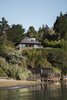 Modern home with Outdoor, Shrubs, Walkways, Trees, and Slope. The property, situated on a steep bluff overlooking the San Francisco Bay, includes a main house with a deck, a pool, an outdoor kitchen, and a boathouse. Photo 11 of Haiku House