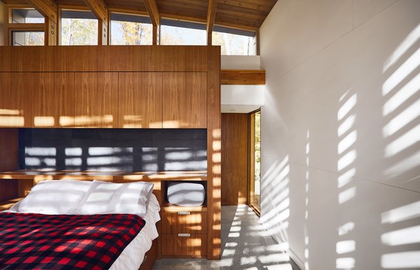 Walnut ply millwork by Ashley Woodturning and polished concrete floors with radiant heating appear throughout the residence.