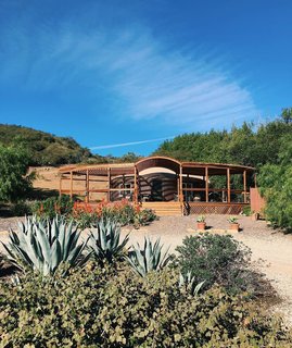 Adrian Larralde built the original yurt in 2010 and added the porch in mid-2017, extending the living space toward beach views. 