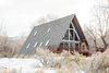 Modern home with Exterior, Wood Siding Material, A-Frame RoofLine, Shingles Roof Material, House, and Cabin Building Type. The cabin’s clean-lined, rustic-modern decor was inspired by her own Scandinavian heritage, and she gave much thought to finding balance between the traditional A-frame layout and her redesign. Photo of A-Frame Haus