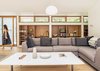 Modern home with Living Room, Sectional, Shelves, Coffee Tables, Pendant Lighting, Recessed Lighting, and Medium Hardwood Floor. Recessed built-ins made of Douglas fir were milled by TJM Custom Interiors. Photo 3 of House on Lake Havelock
