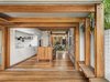 Modern home with Kitchen, Pendant Lighting, Medium Hardwood Floor, Drop In Sink, Wood Counter, Wood Cabinet, Wall Oven, and White Cabinet. In the kitchen, an island on casters hides a trio of tables that can be configured in multiple ways both indoors and out. Photo 4 of Aquas Perma Solar Firma