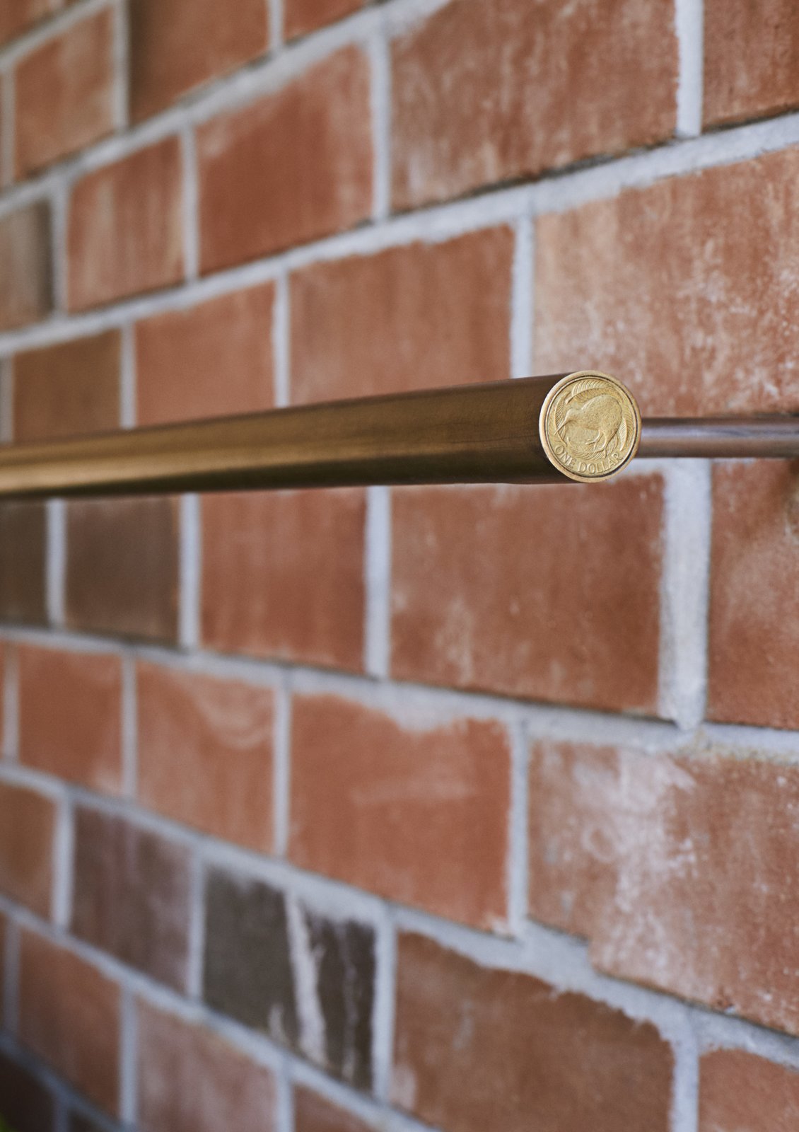 <b>Door Pulls & Lights:</b> Grant made many of the light fixtures and door pulls himself using brass tubing. For the lights, he realized that a New Zealand dollar coin was the perfect size for the end caps, a discovery that saved him $36 on store-bought versions.”></a></noindex></noindex></figure>
<figure><noindex><noindex><a target=
