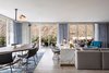 Modern home with Living Room, Table, Sectional, Pendant Lighting, Desk, Light Hardwood Floor, Chair, and Rug Floor. Kimpton Rowan Palm Springs Hotel in Palm Springs, California Photo 3 of Kimpton Rowan Palm Springs Hotel