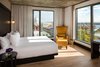 Modern home with Bedroom, Bed, Night Stands, Chair, Light Hardwood Floor, and Wall Lighting. All of the rooms have been meticulously designed with contemporary furnishings, thoughtful amenities, original local art, and an inviting, open feel. Photo 5 of Hotel William Gray