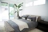 Modern home with Bedroom, Rug Floor, Table Lighting, Night Stands, and Bed. This serene bedroom comes complete with a Tuft & Needle mattress and luxe Belgian Flax bed linens by West Elm. Photo 9 of The Brexley