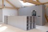 Modern home with Kitchen, Light Hardwood Floor, and Wall Oven. The couple’s private kitchen is covered in an easy-to-clean, water-repellent matte surface called Fenix. Photo 4 of Moosham 13