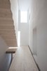 Modern home with Wood Tread and Staircase. The couple’s private kitchen is covered in an easy-to-clean, water-repellent matte surface called Fenix. The floating spruce staircase (above) is housed in a new tower-like volume. Photo 5 of Moosham 13