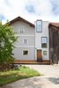 Modern home with Outdoor, Back Yard, Wood Patio, Porch, Deck, Trees, Grass, and Hardscapes. From the outside, the tower-like volume hints at the minimalist transformation within. The second-floor vacation suite (below) has a convertible Softline sofa and cardboard stools from Stange Design. The storage unit is clad in black MDF. Photo 6 of Moosham 13