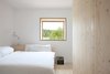 Modern home with Bedroom, Table Lighting, Light Hardwood Floor, and Bed. Carpenter Martin Bernauer built custom beds for the vacation suites. Photo 9 of Moosham 13