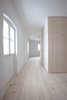 Modern home with Hallway and Light Hardwood Floor. In each unit, the architects placed storage and a bathroom in a self-contained wood cube in the middle of the space. Photo 10 of Moosham 13