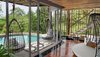 Modern home with Living Room, Medium Hardwood Floor, and Chair. Cocoon loungers hang by the infinity pool in one of the Tree Pool Houses, inspired by a mystical We-ha (Sky) Clan, a creative group that included healers, creators, architects, and inventors. Photo 5 of Keemala