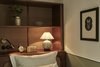 Modern home with Bedroom, Table Lighting, Wall Lighting, Shelves, and Bed. The Coupé rooms are ideal for the individual traveller looking to spend a night in Sanders’ cosy, intimate surroundings. The design is inspired by luxury train cabins from the golden age of travel, providing plenty of comfort and luxury in the relatively limited space. The bedrooms consist of a single bed and a private bathroom with walk-in shower and lavatory, and they face the residential courtyard. Photo 11 of Hotel Sanders