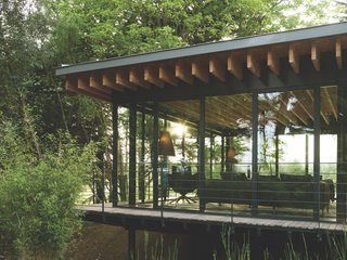 The glass-and-steel extension allows the homeowners to embed themselves in the natural environment.