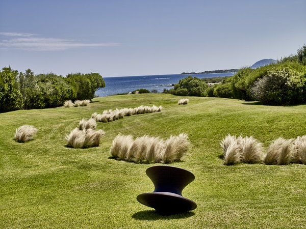 When Ferdinando Fagnola co-designed a series of avant-garde Brutalist villas on the Sardinian coast in the mid-1970s, he had no idea he would return one day with a group of younger architects to transform a trio of them into one home for new owners. Each villa consists of seemingly discrete, half-buried concrete volumes emerging from the earth. A Spun chair by Thomas Heatherwick for Magis is oriented toward the sea.