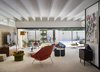 Modern home with Living Room, Carpet Floor, Chair, Sectional, and Coffee Tables. The 1946 Womb Chair by Eero Saarinen by Knoll was reupholstered in Knoll Boucle Orange. Photo 13 of The Ellison House