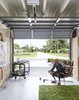 Modern home with Garage and Garage Conversion Room Type. Christopher, known professionally as Flore, surveys a painting in his garage turned studio. Photo 8 of The Ellison House