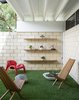 Modern home with Outdoor and Grass. Leedy’s signature precast double- T concrete beams create overhangs. Christopher furnished the patio with a red GN2 lounge chair by Peter Ghyczy and Maya chairs from CB2. Photo 6 of The Ellison House