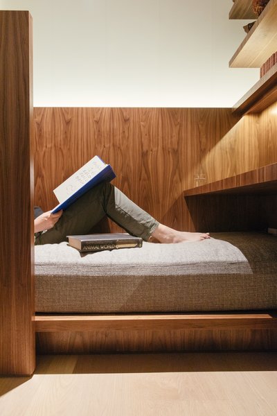 In addition to a desk, there’s a tucked-in bed for reading or relaxing. 